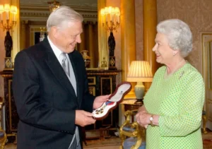 David Attenborough receiving an honour from Queen Elizabeth II at Buckingham Palace, the Queen presenting him with a cased insignia