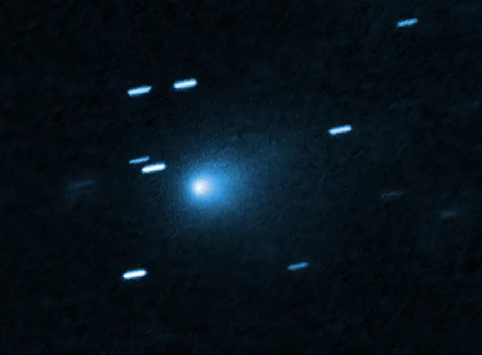 Hubble Space Telescope image of Comet 3I/ATLAS showing a bright core and a teardrop-shaped coma of gas and dust.