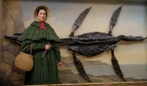 A digital composite image featuring the 1842 portrait of Mary Anning seamlessly blended with a high-resolution photograph of her actual Ichthyosaurus discovery from a museum exhibition.