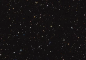 Thousands of multicoloured distant galaxies of various shapes and sizes densely packed across the frame.