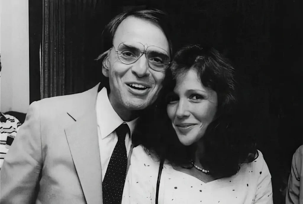 Carl Sagan and Ann Druyan photographed together, both smiling, in a black and white portrait